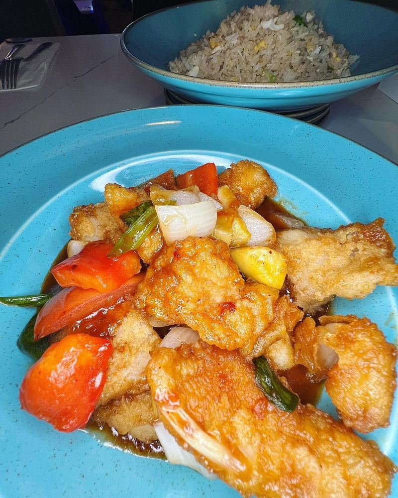 Crispy sweet and sour fish with tomato and pineapple