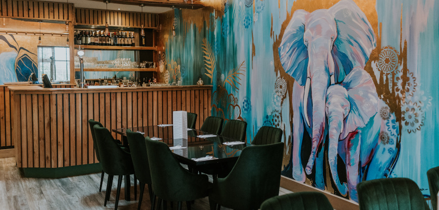 The private room upstairs at May's Thai, with the bar and elephant mural